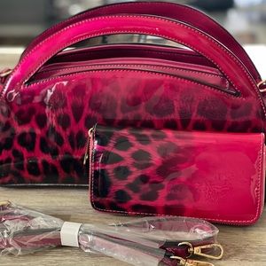 She’s a dark pink/ magenta, cheetah print ombré purse. Shiny patten leather.